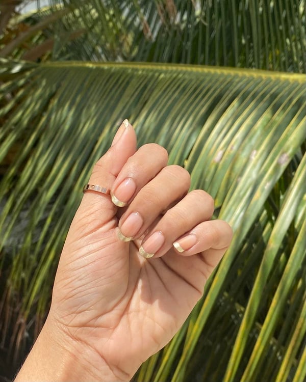 Picture by hemanshi95 saying 'Colour Has Been Overwhelming Me Lately So I Went For A Simple Naked Mani And Gold Tips ✨'